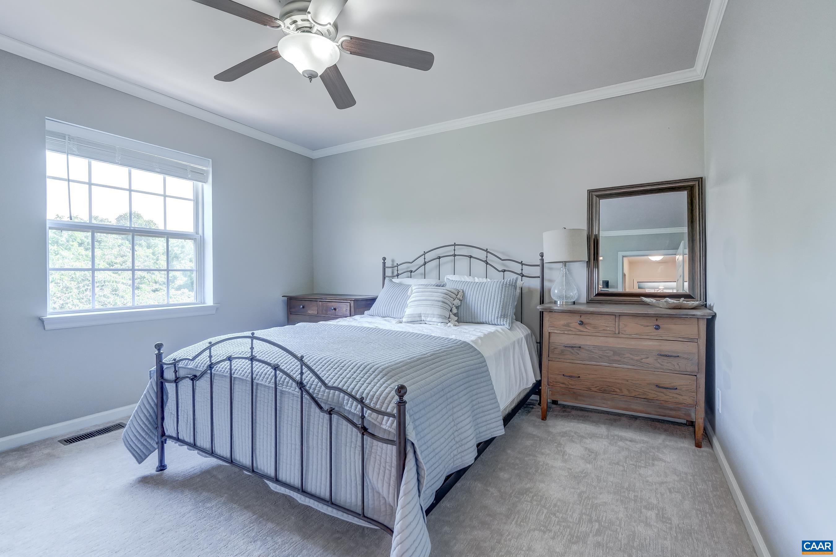1069 Amber Ridge Road Charlottesville, VA 22901 - Photo 27 of 46 a bedroom with a bed and a chandelier fan