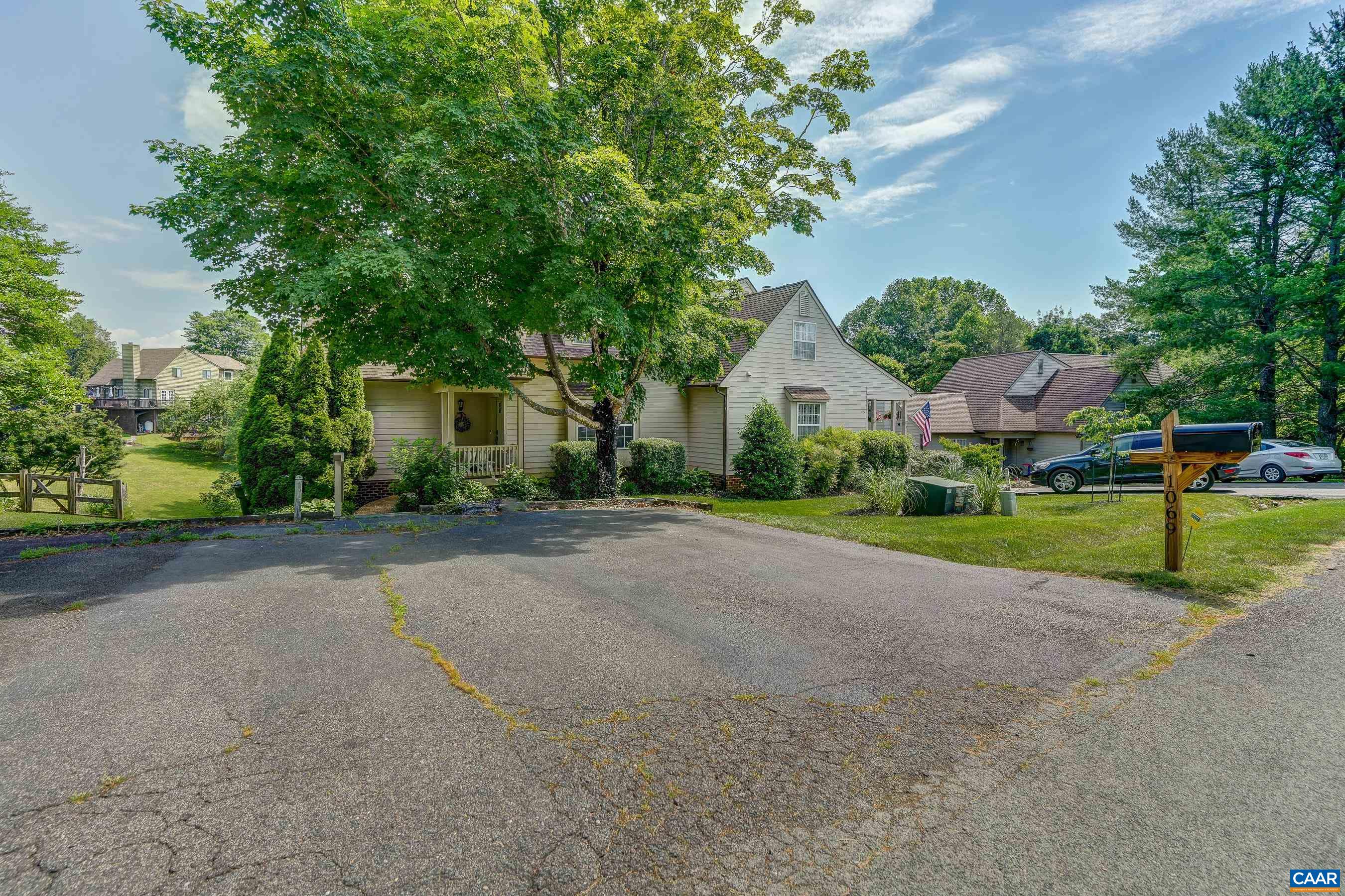 1069 Amber Ridge Road Charlottesville, VA 22901 - Photo 43 of 46 a view of a house with a big yard and large trees