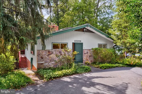 a front view of house with a garden