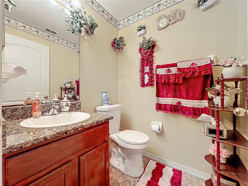 7939 Riffle Lane Orlando, FL 32818 - Photo 18 of 52 a bathroom with a sink vanity mirror and toilet