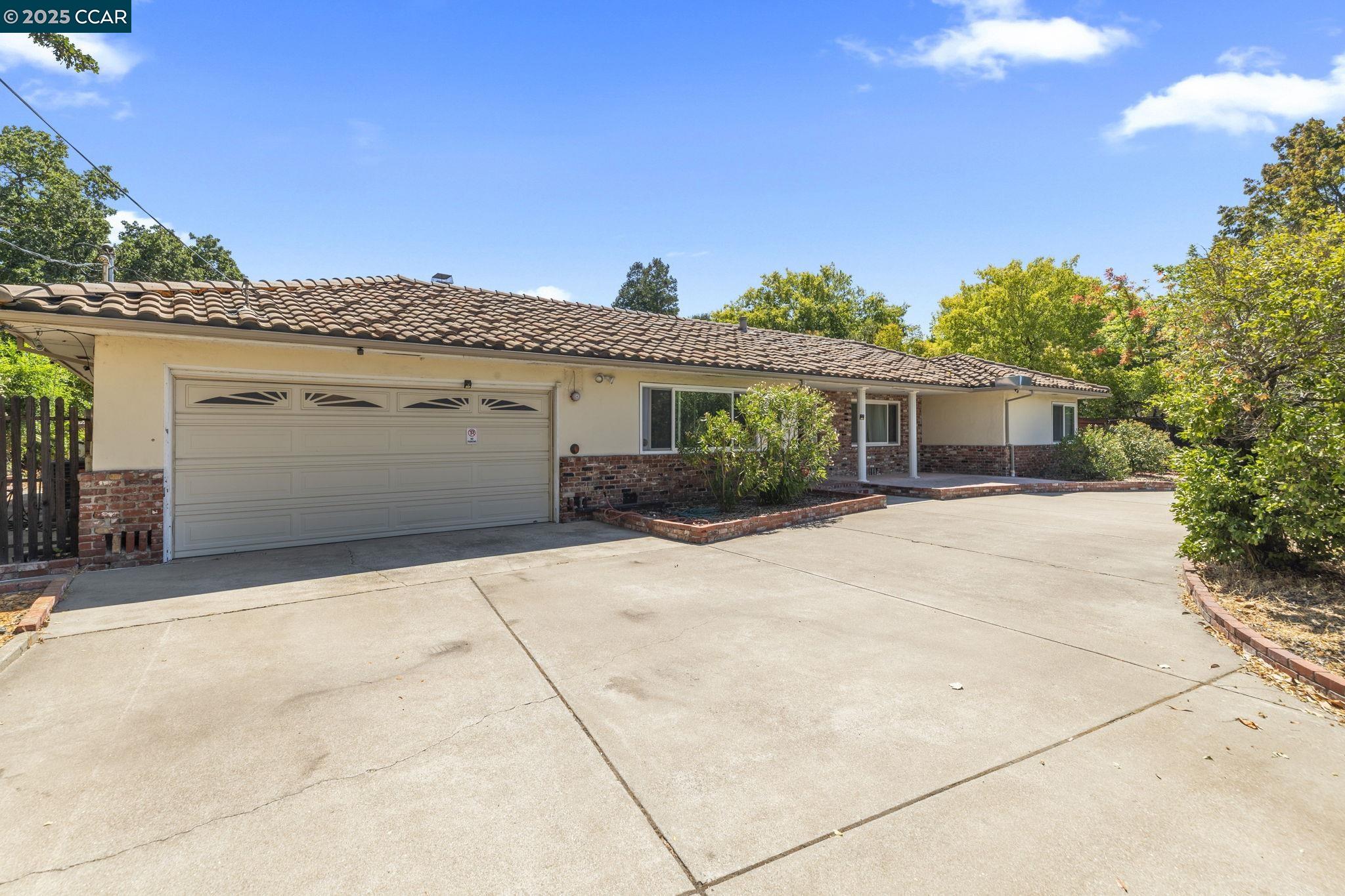 1910 San Miguel Drive Walnut Creek, CA 94596 - Photo 1 of 58 a front view of a house with a garage