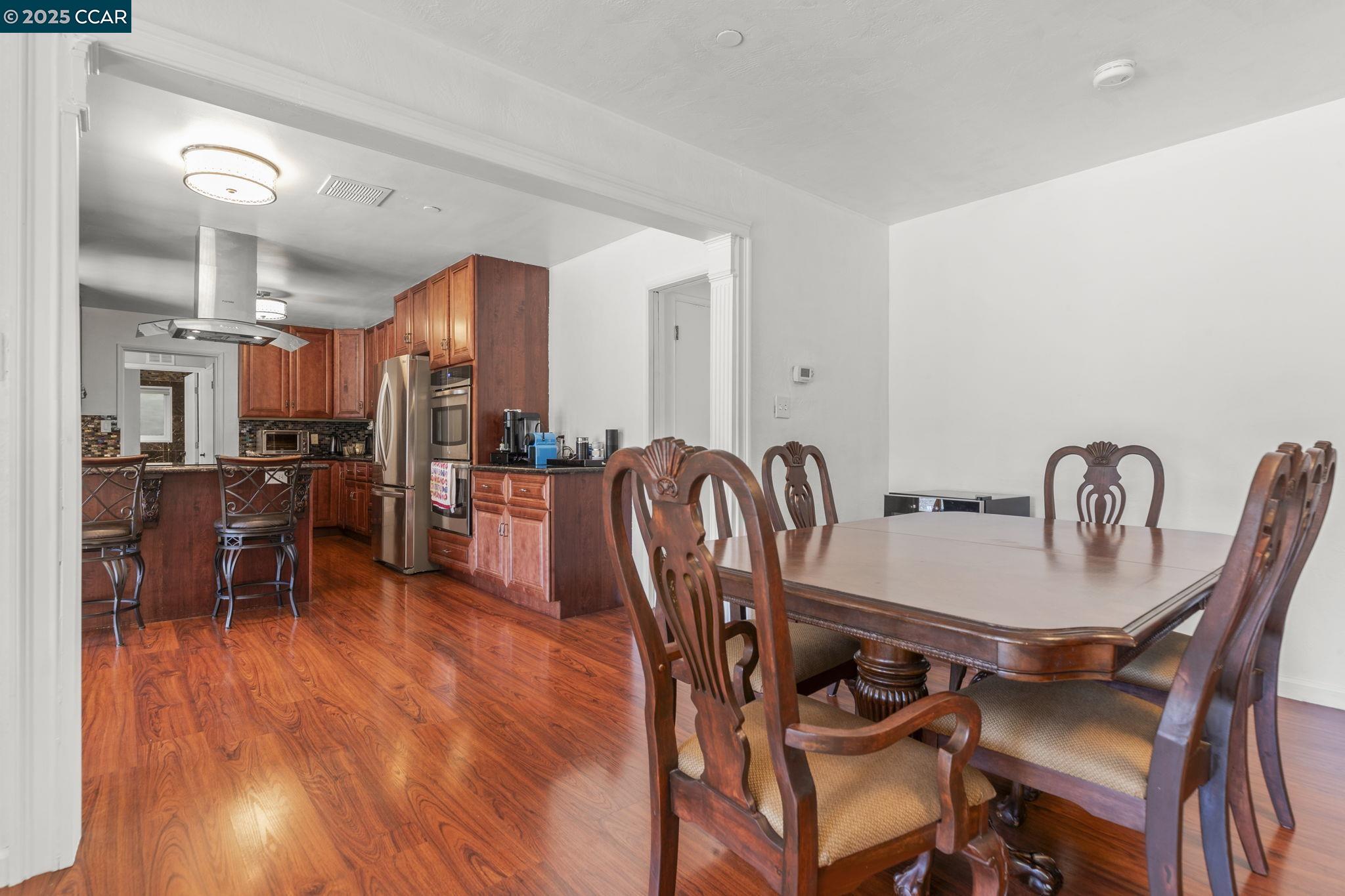 1910 San Miguel Drive Walnut Creek, CA 94596 - Photo 16 of 58 a dining room with furniture and wooden floor