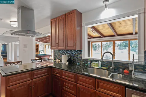 a kitchen with stainless steel appliances a sink and cabinets