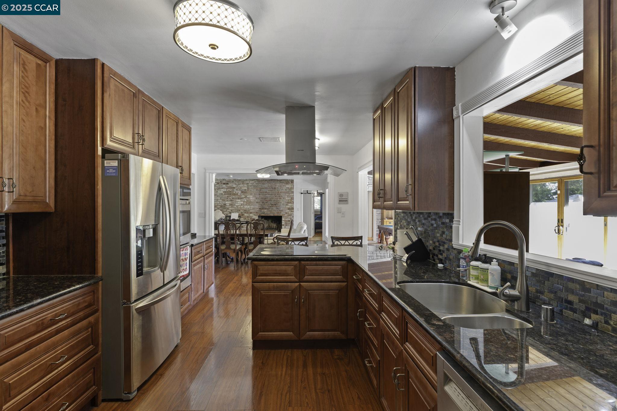 1910 San Miguel Drive Walnut Creek, CA 94596 - Photo 19 of 58 a kitchen with stainless steel appliances granite countertop a sink stove and refrigerator
