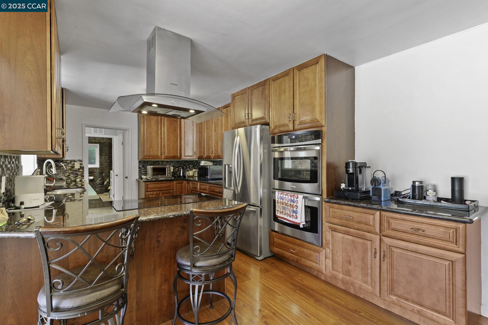 1910 San Miguel Drive Walnut Creek, CA 94596 - Photo 21 of 58 a kitchen with stainless steel appliances a sink and cabinets