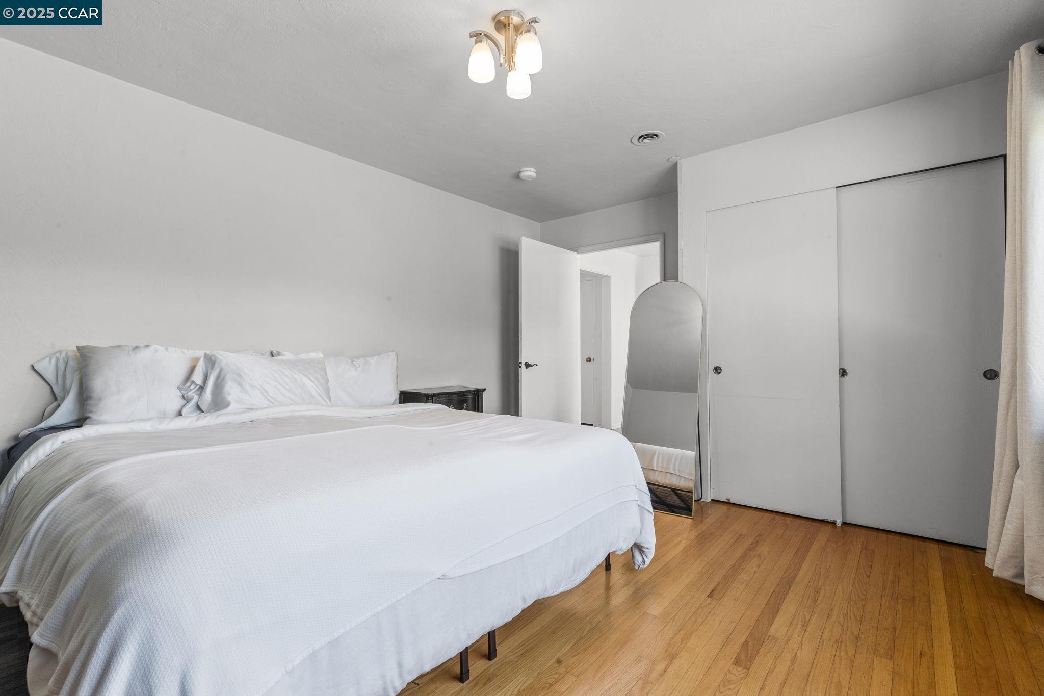 1910 San Miguel Drive Walnut Creek, CA 94596 - Photo 22 of 58 a bedroom with a bed and a chandelier