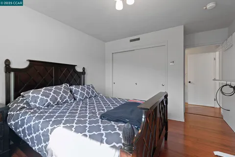 a bed sitting in a bedroom next to a window