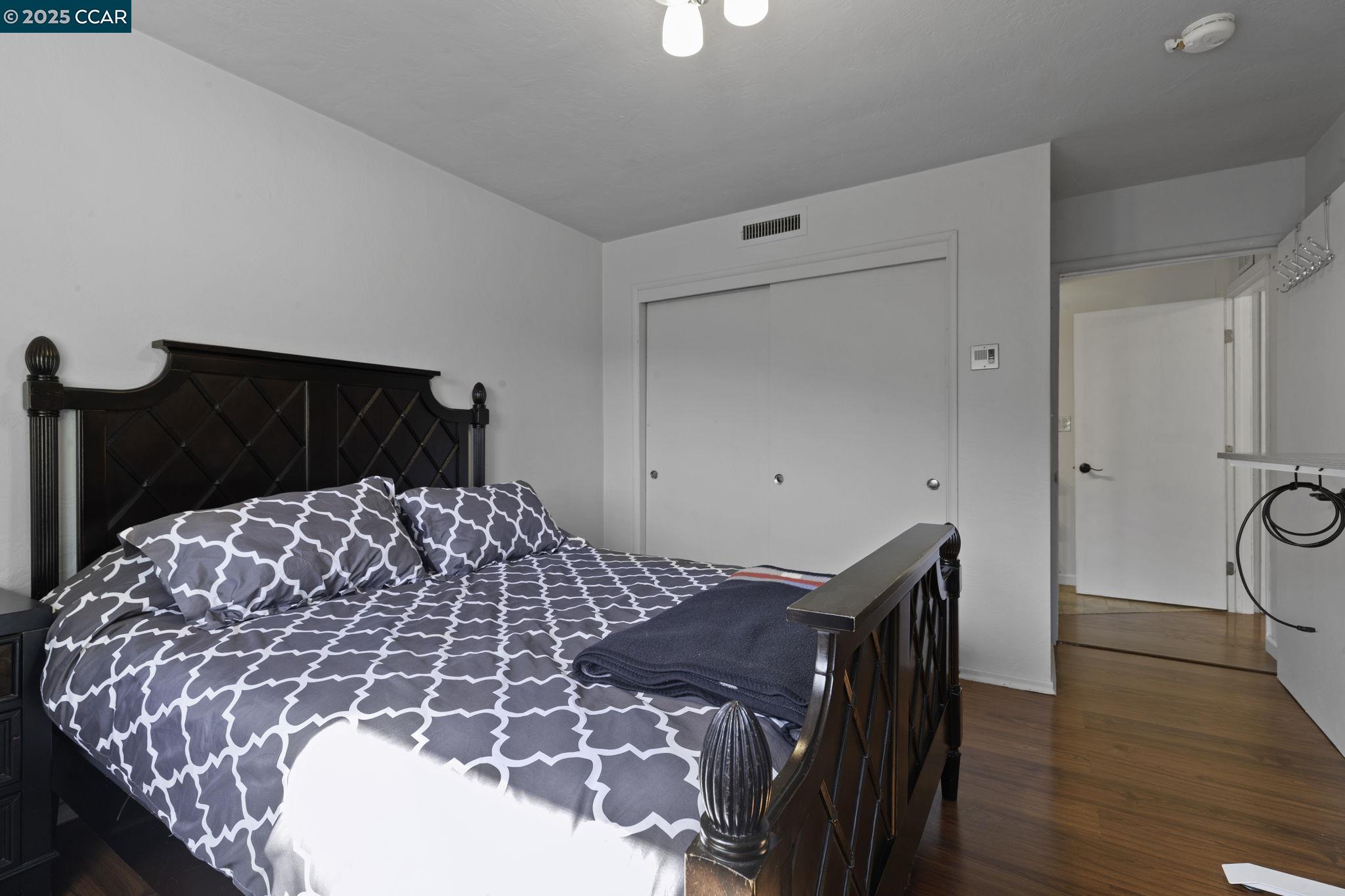 1910 San Miguel Drive Walnut Creek, CA 94596 - Photo 24 of 58 a bedroom with a bed and wooden floor