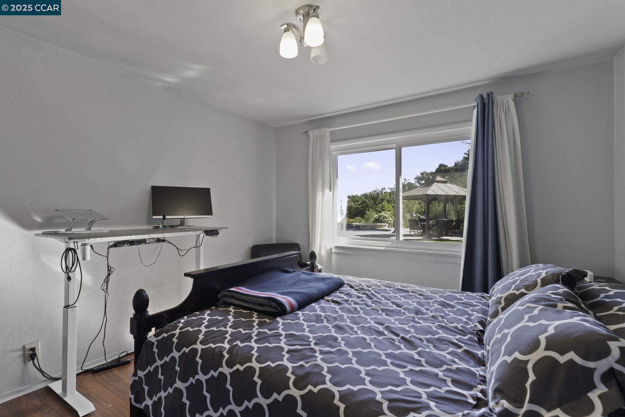 1910 San Miguel Drive Walnut Creek, CA 94596 - Photo 25 of 58 a bed sitting in a bedroom next to a window