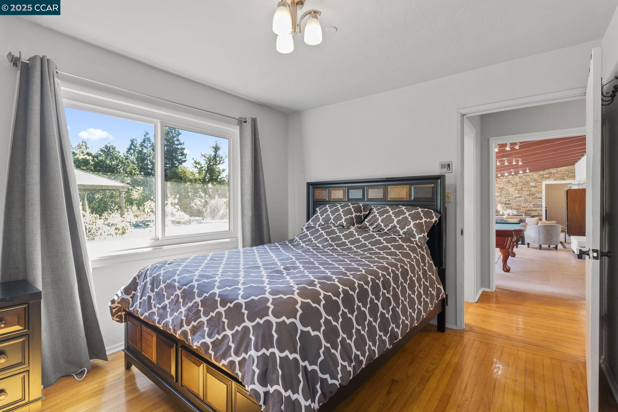 1910 San Miguel Drive Walnut Creek, CA 94596 - Photo 29 of 58 a bedroom with a bed and wooden floor