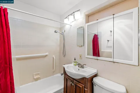 a view of an outdoor dining space with a table and chairs under an umbrella