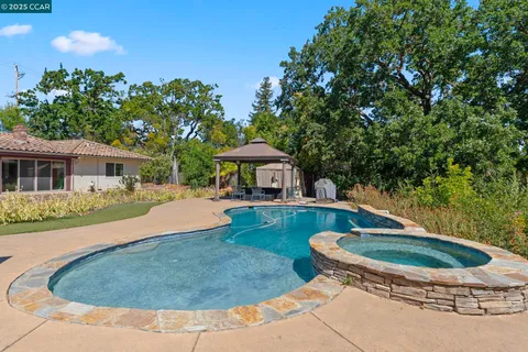 an aerial view of a house with a yard and garden