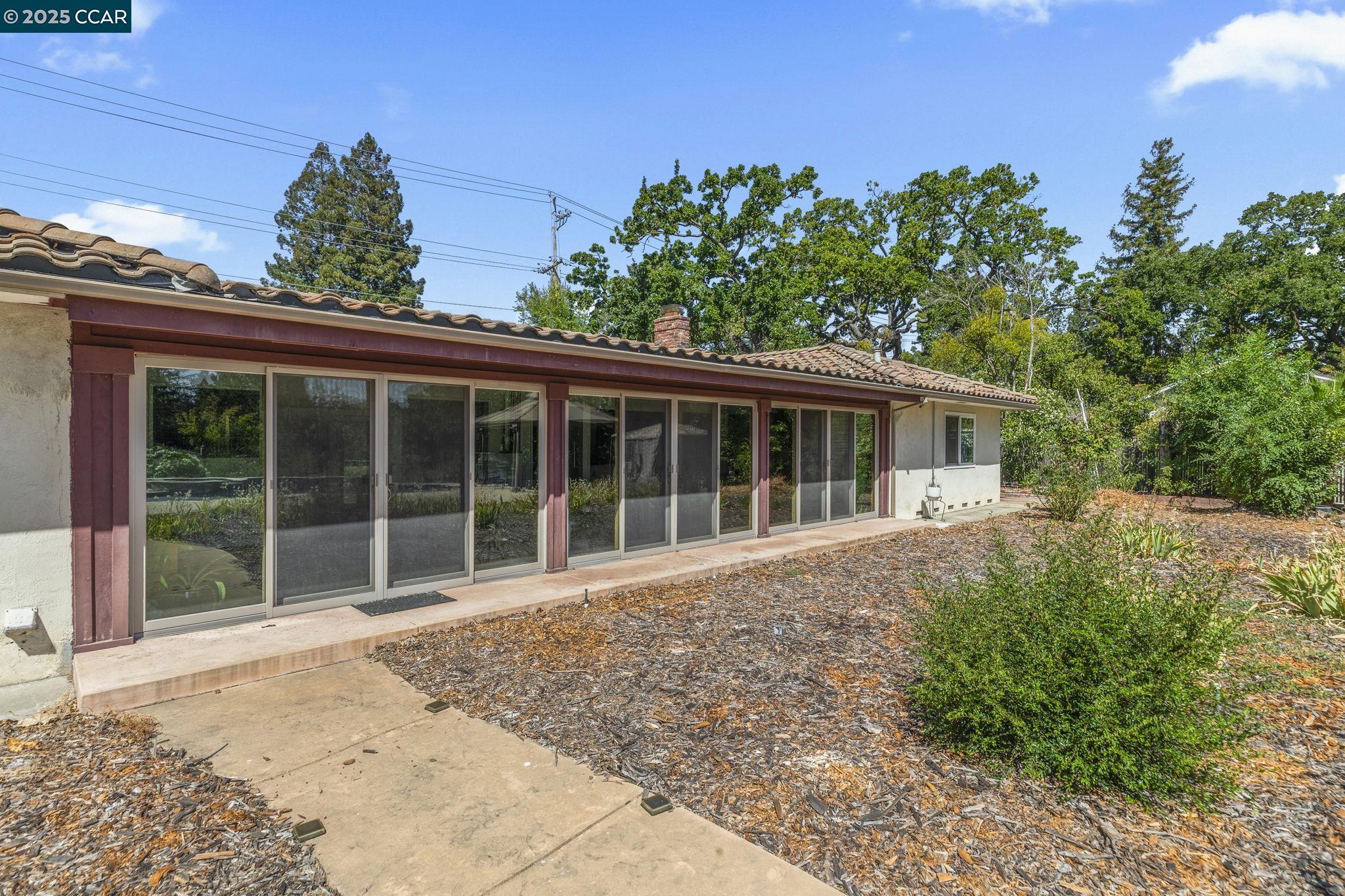 1910 San Miguel Drive Walnut Creek, CA 94596 - Photo 37 of 58 a view of a house with a garden