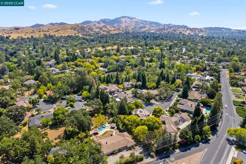 a kitchen with stainless steel appliances wooden floor dining table and chairs