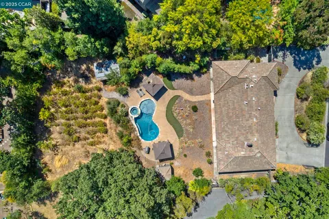 a kitchen with stainless steel appliances granite countertop a refrigerator a stove and a sink