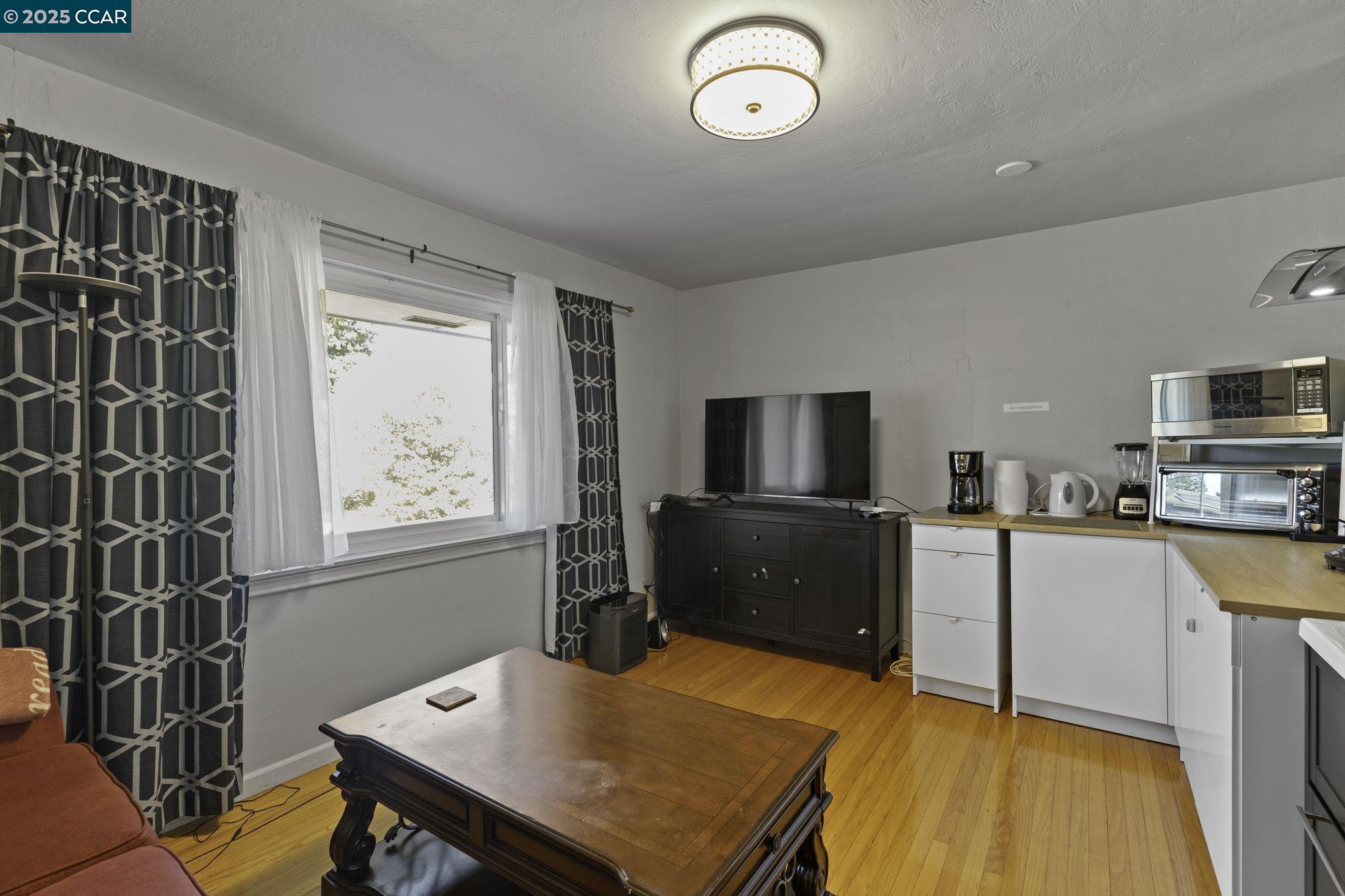 1910 San Miguel Drive Walnut Creek, CA 94596 - Photo 49 of 58 a kitchen with stainless steel appliances wooden floor dining table and chairs