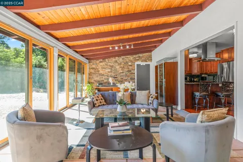 a room with pool table and windows