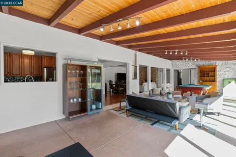 a room with pool table and glass door