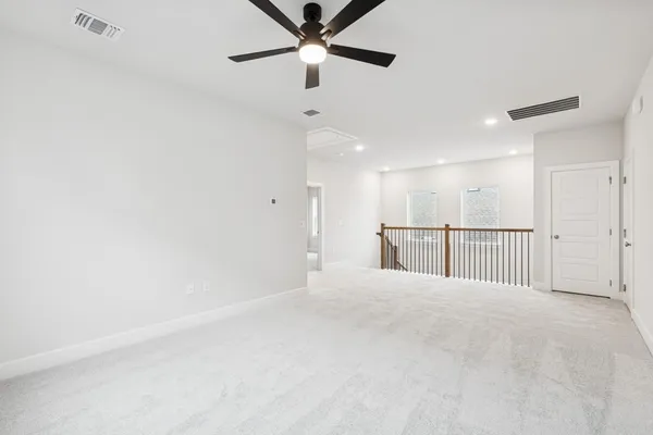 a view of a livingroom with a ceiling fan and window