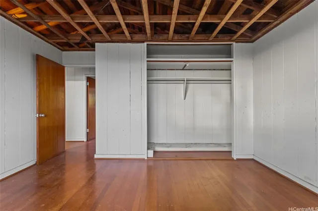 a view of a room with wooden floor and windows