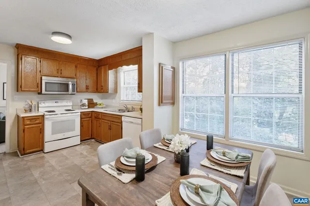 a kitchen with furniture a sink and a view of living room