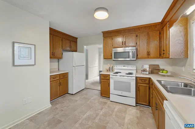 a kitchen with cabinets stainless steel appliances and a sink