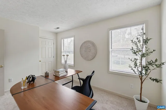a view of a room with a table and chairs