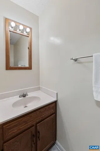 a bathroom with a sink vanity and a mirror