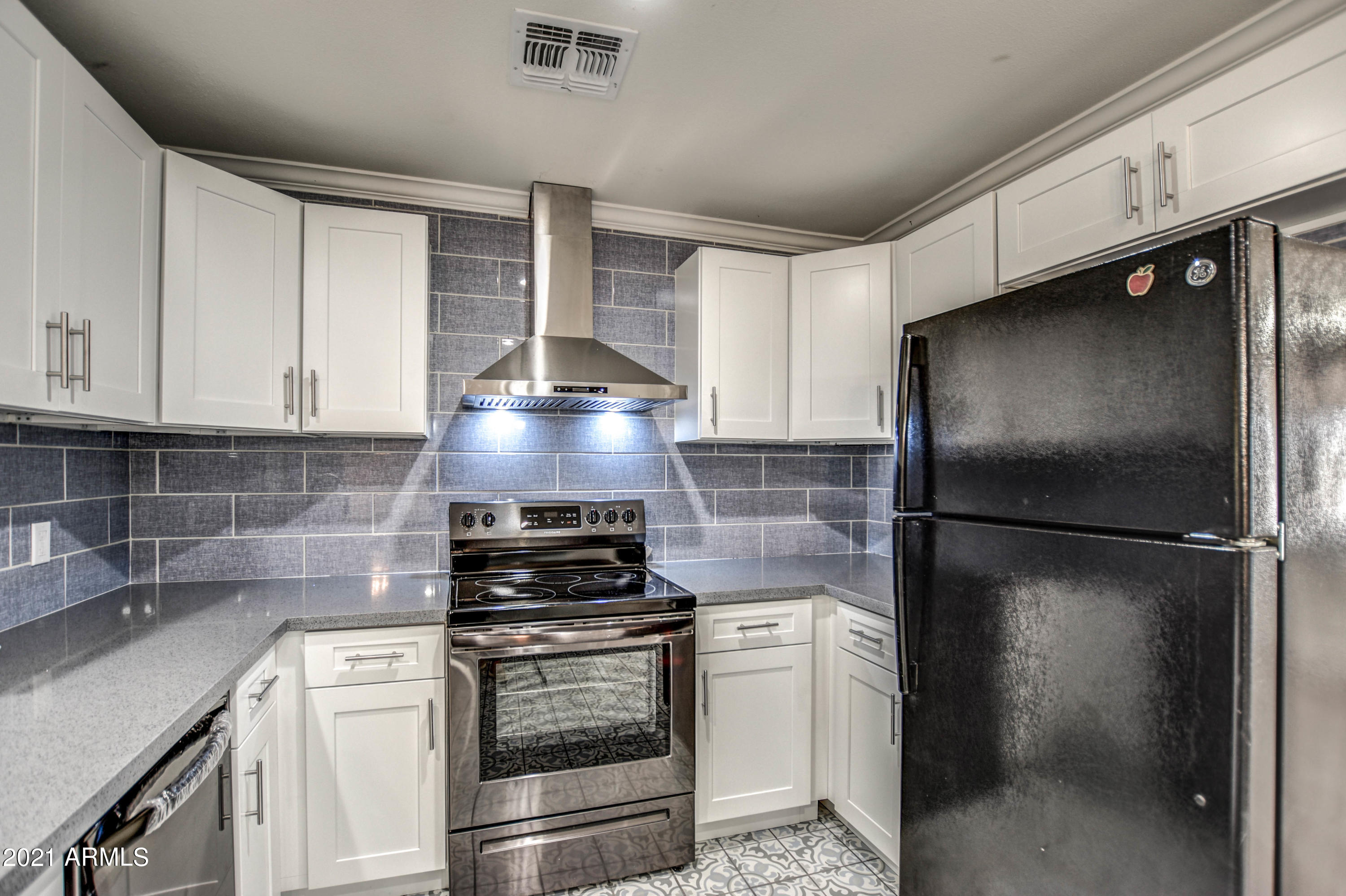 5743 Casper Road Mesa, AZ 85205 - Photo 1 of 43 a kitchen with a refrigerator and a stove top oven