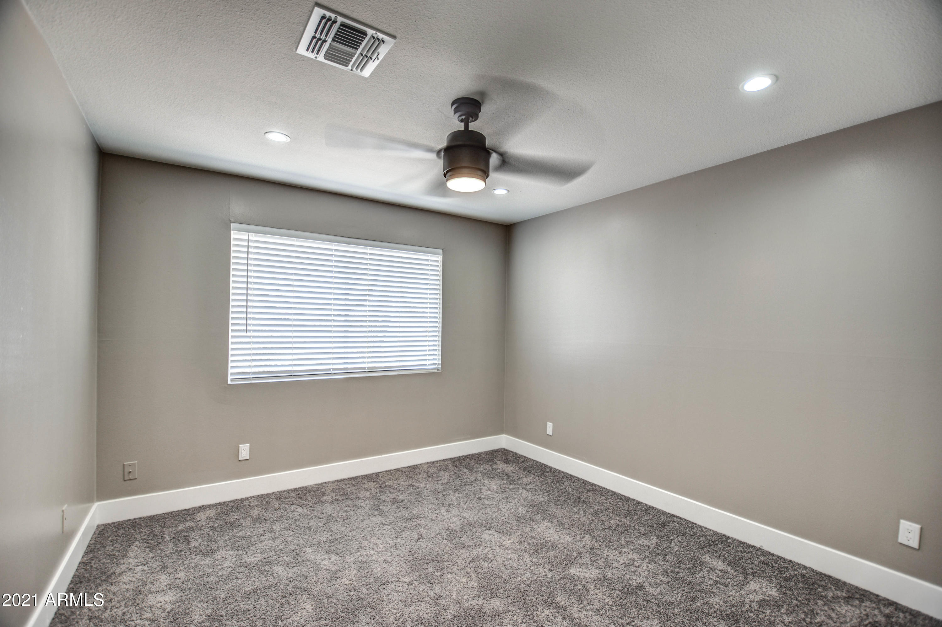 5743 Casper Road Mesa, AZ 85205 - Photo 11 of 43 an empty room with a window