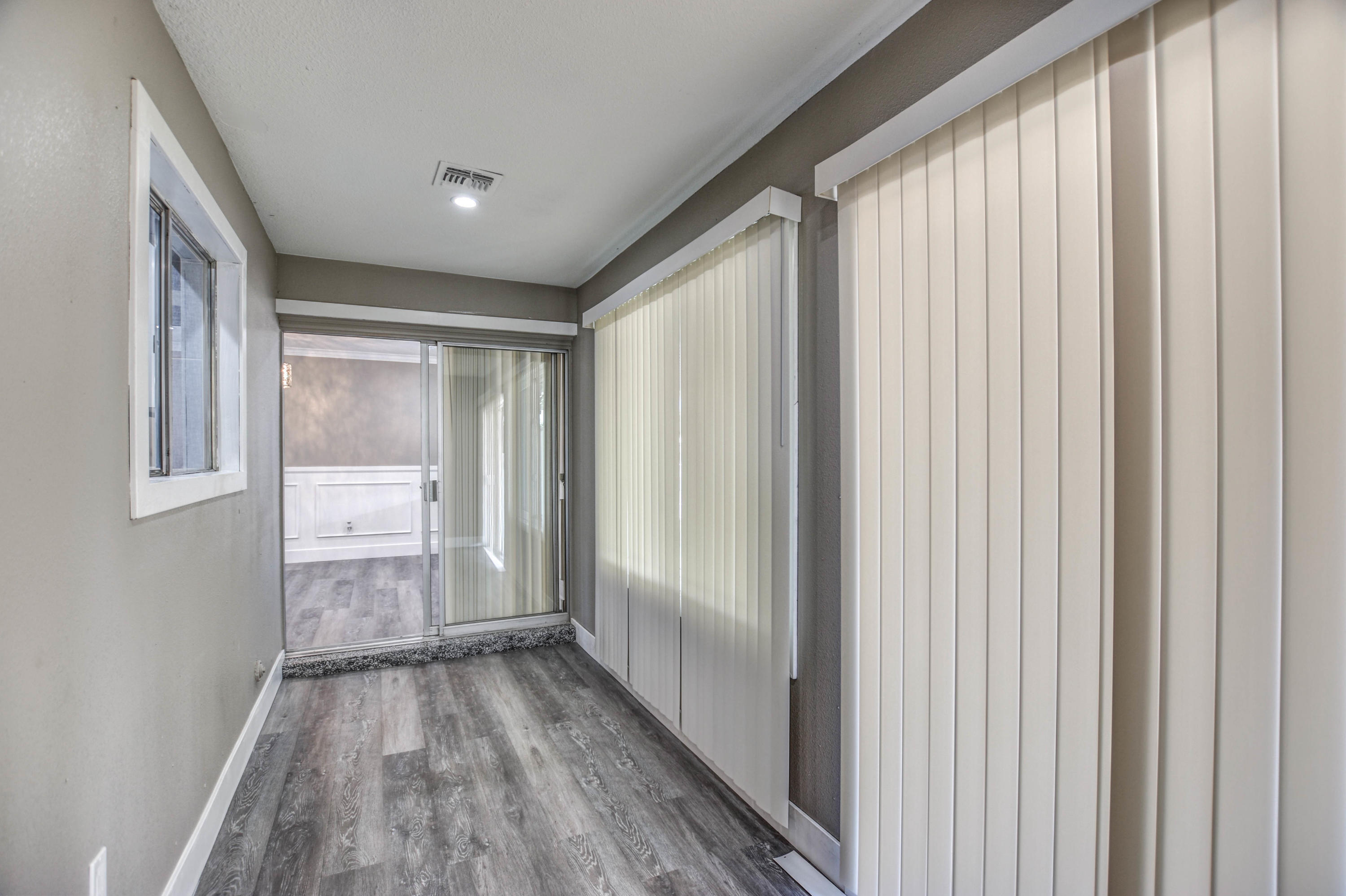 5743 Casper Road Mesa, AZ 85205 - Photo 13 of 43 a view of empty room with wooden floor and fan