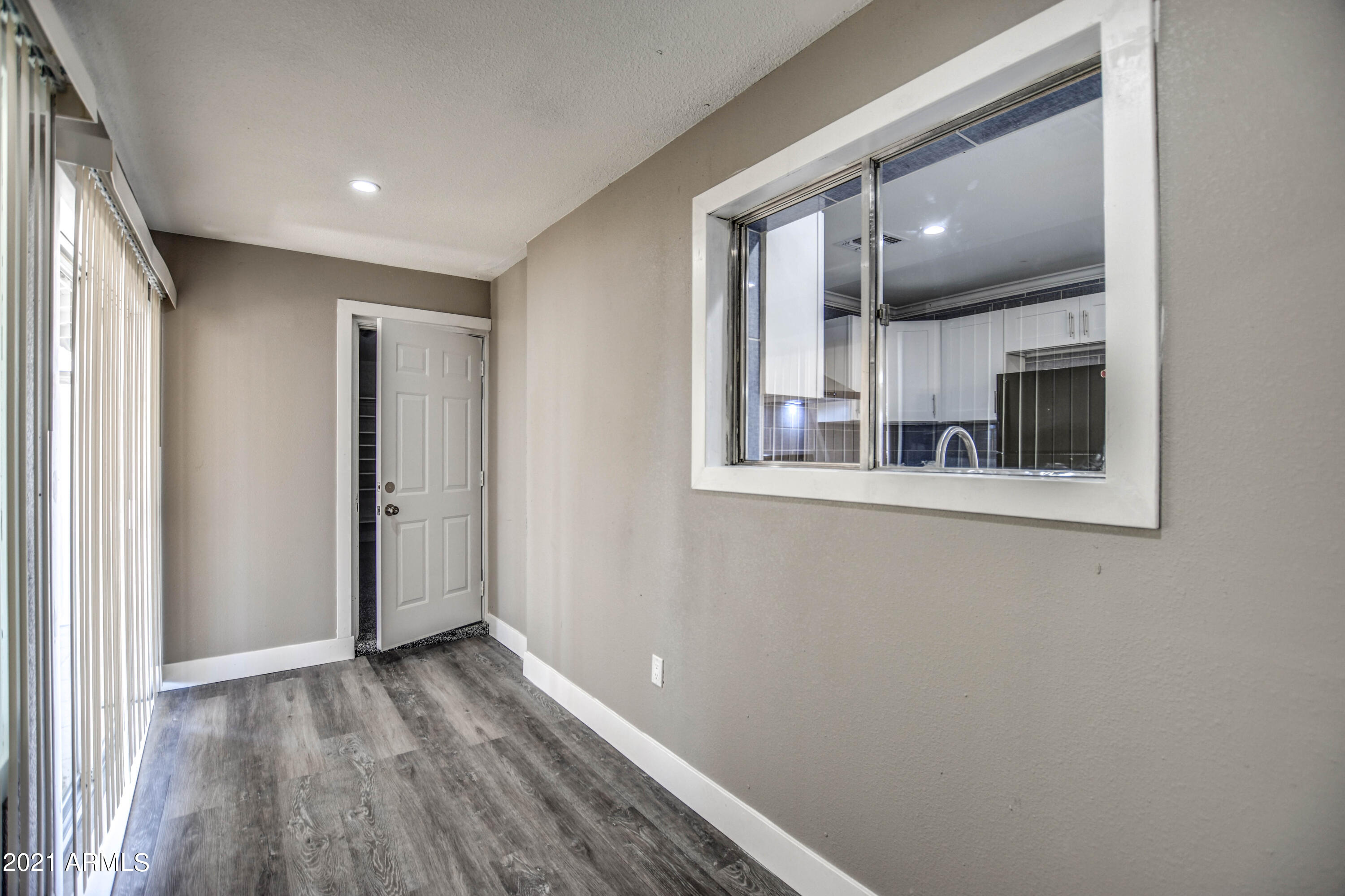 5743 Casper Road Mesa, AZ 85205 - Photo 14 of 43 a view of a hallway with wooden floor and staircase