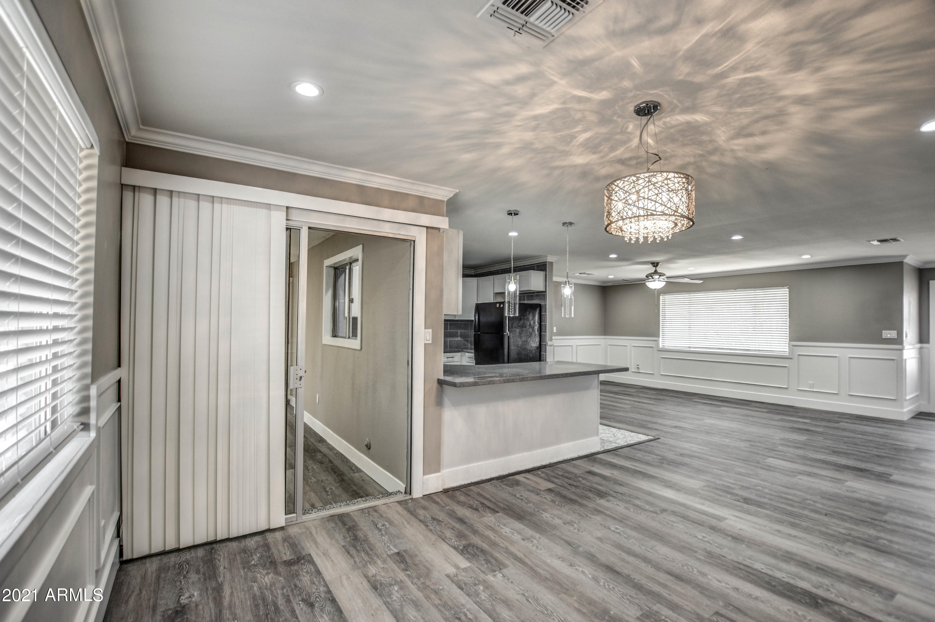 5743 Casper Road Mesa, AZ 85205 - Photo 16 of 43 a view of a living room and kitchen with a wooden floor