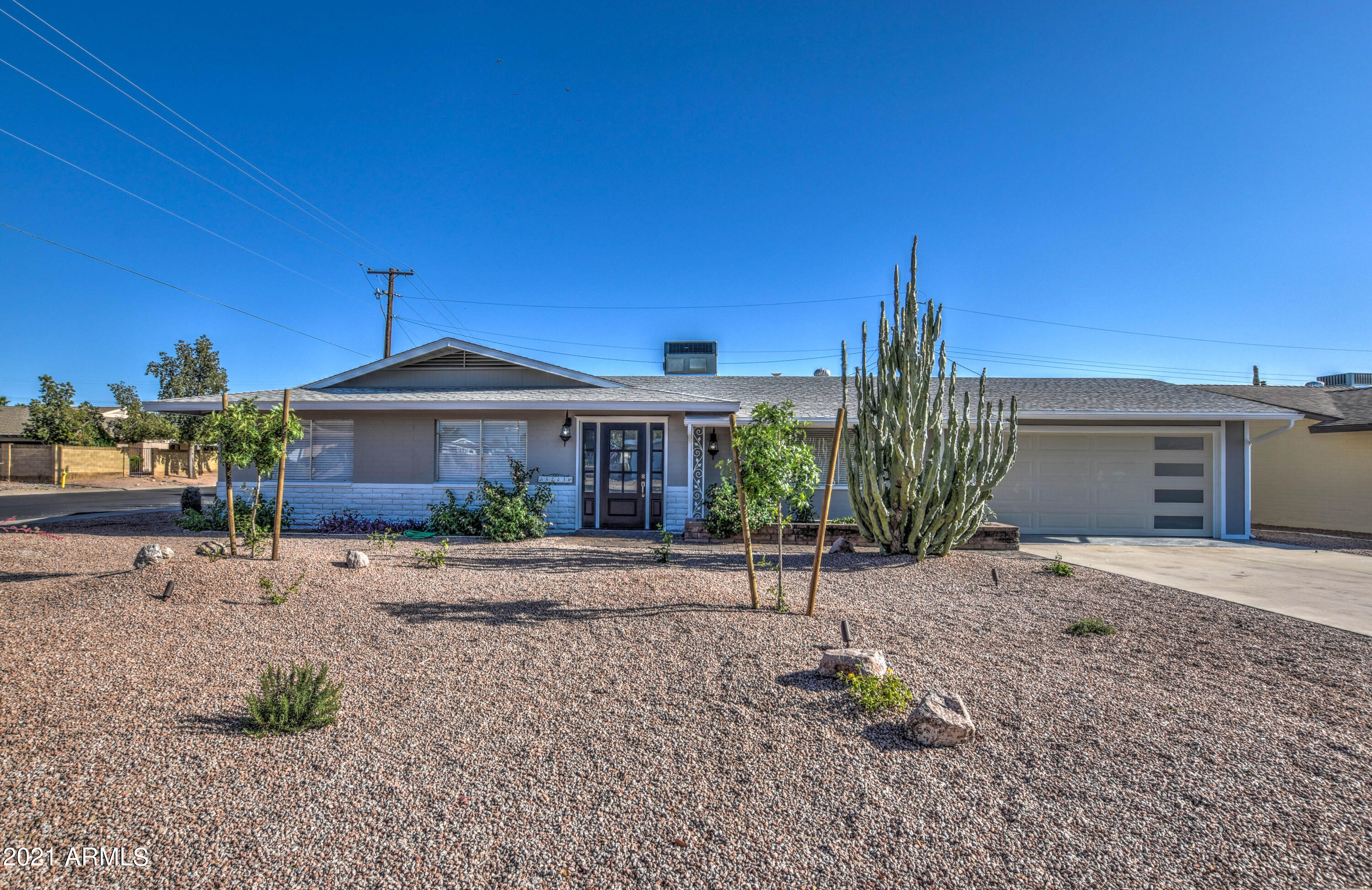 5743 Casper Road Mesa, AZ 85205 - Photo 23 of 43 a front view of a house with a yard and a garage