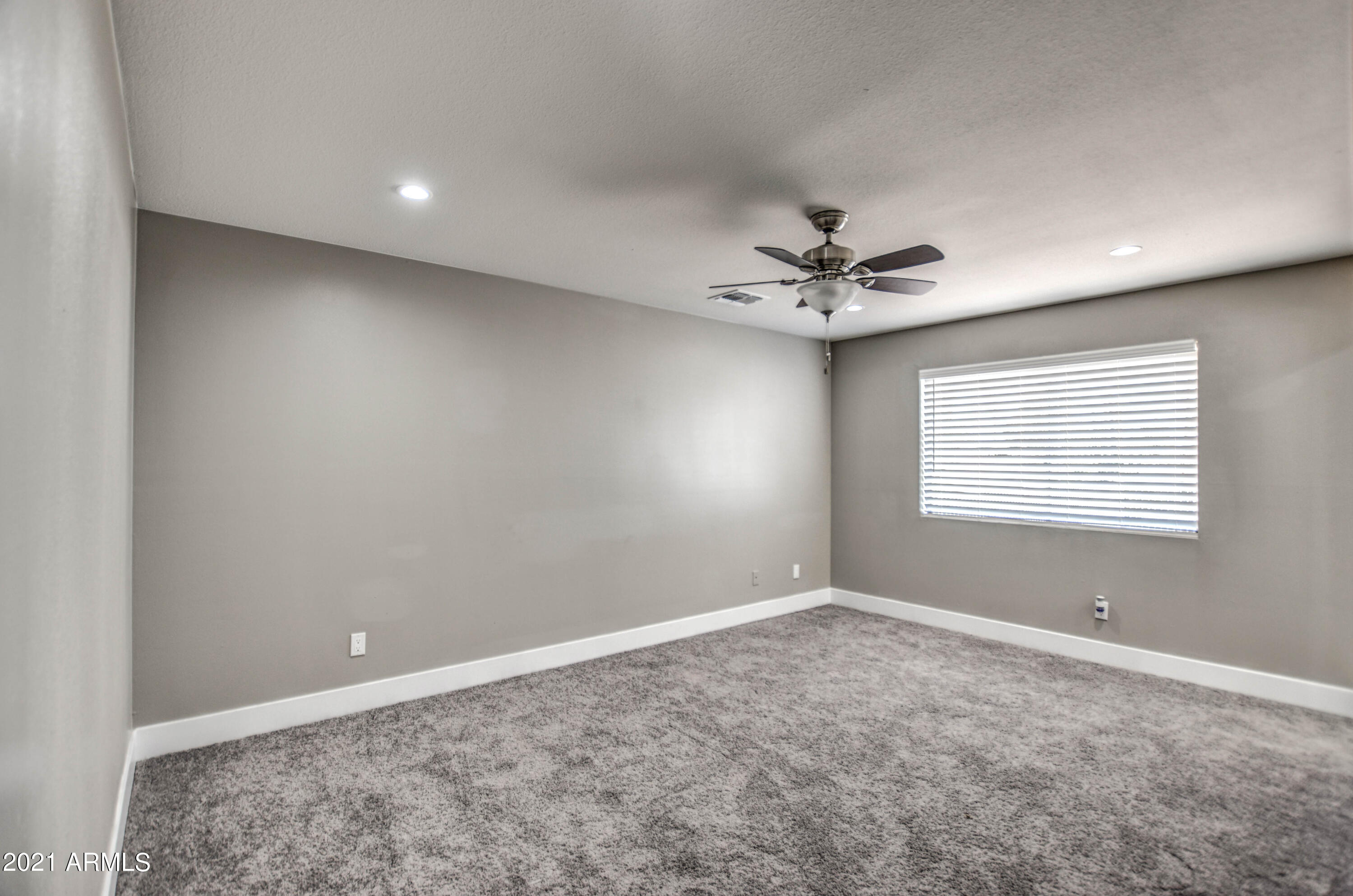 5743 Casper Road Mesa, AZ 85205 - Photo 34 of 43 an empty room with a ceiling fan and window