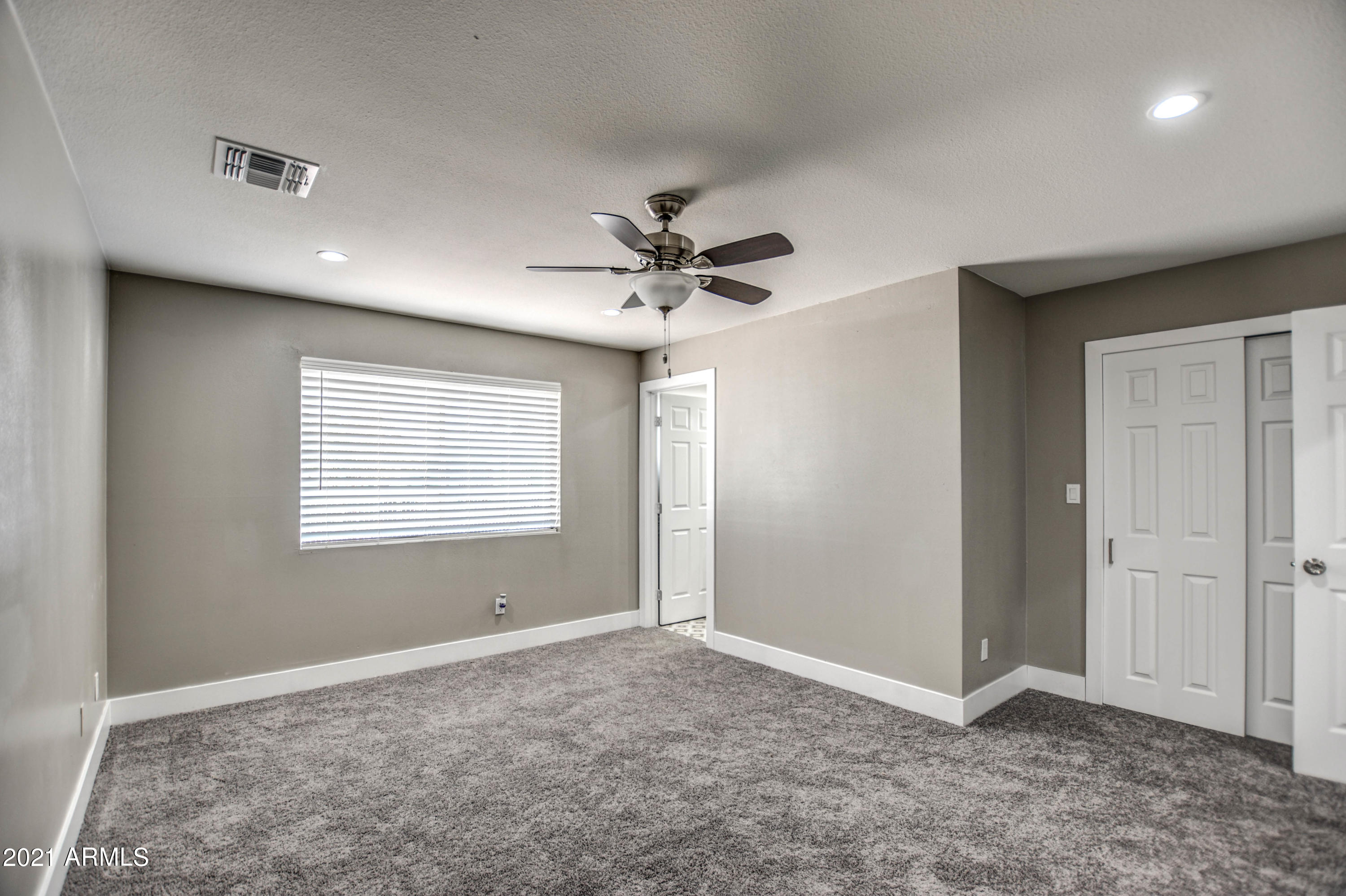 5743 Casper Road Mesa, AZ 85205 - Photo 35 of 43 a view of an empty room with a ceiling fan