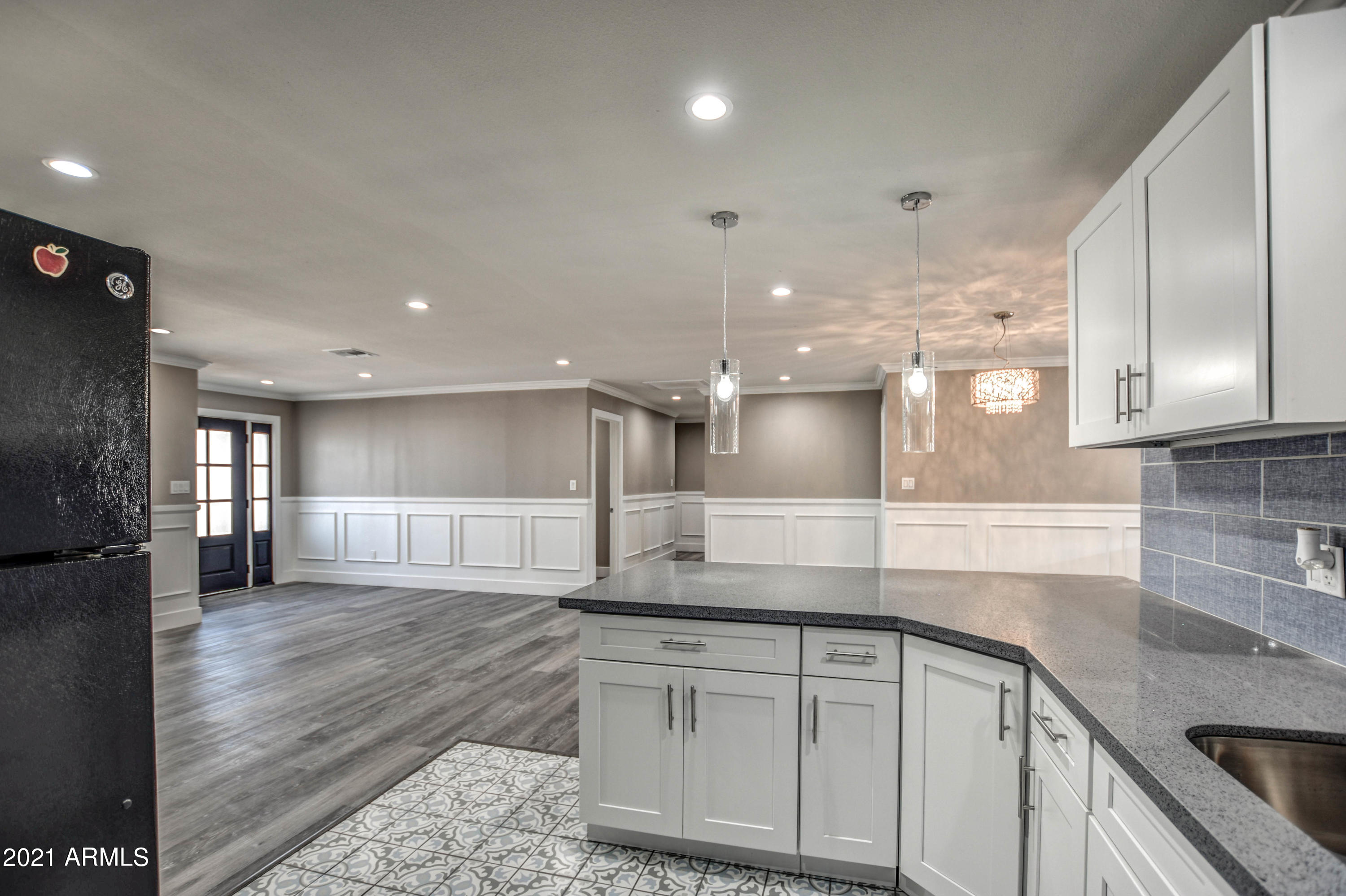 5743 Casper Road Mesa, AZ 85205 - Photo 5 of 43 a large kitchen with stainless steel appliances kitchen island granite countertop a sink and cabinets