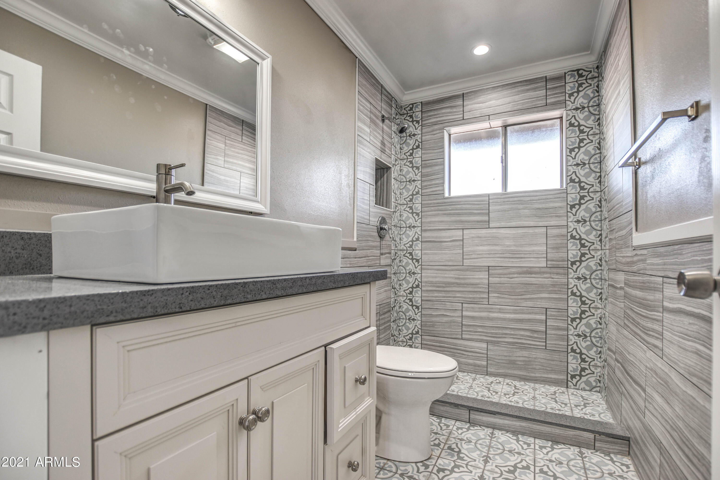 5743 Casper Road Mesa, AZ 85205 - Photo 7 of 43 a bathroom with a sink a toilet and shower