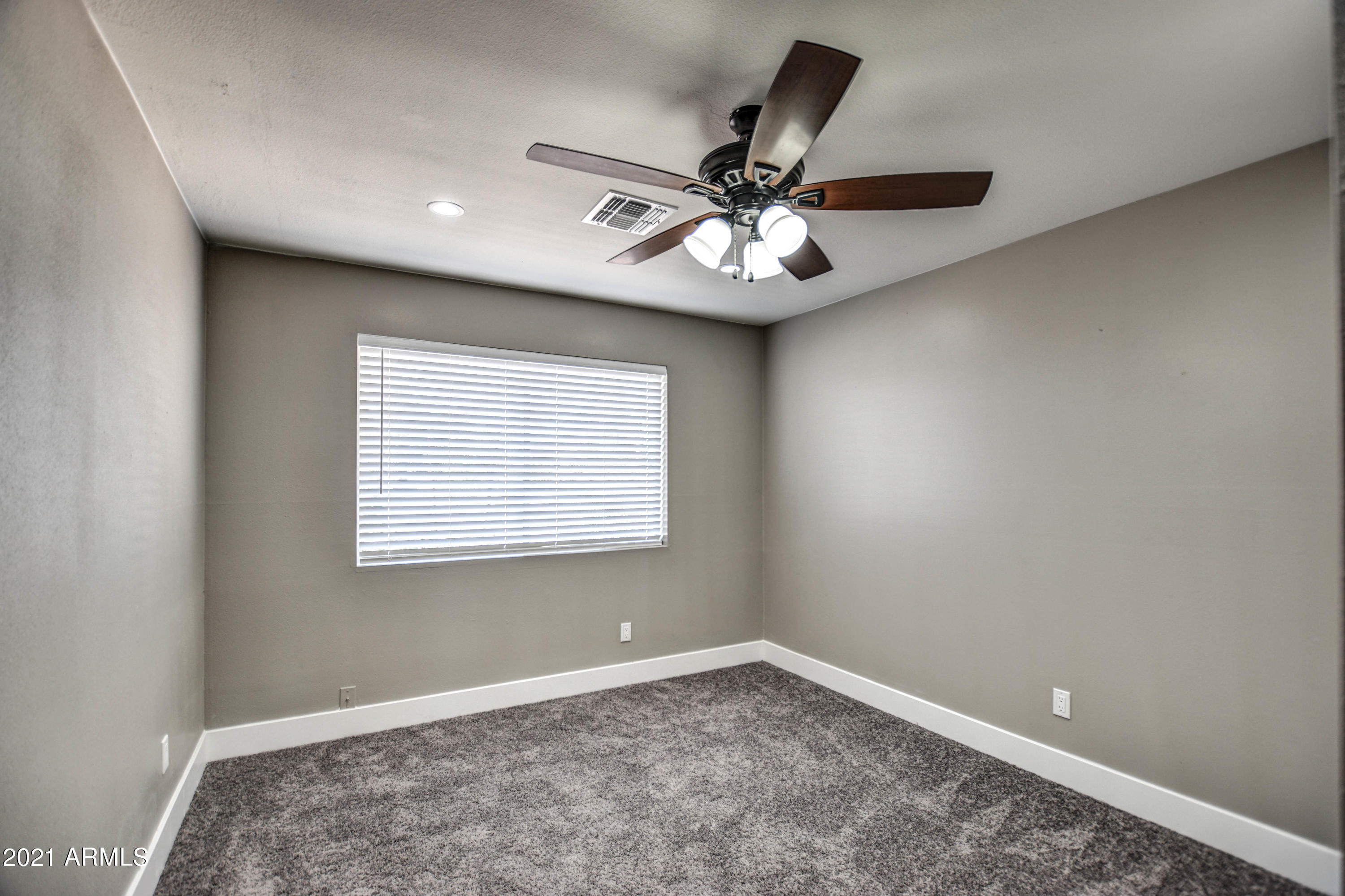5743 Casper Road Mesa, AZ 85205 - Photo 9 of 43 an empty room with a window