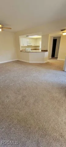 a view of kitchen and empty room