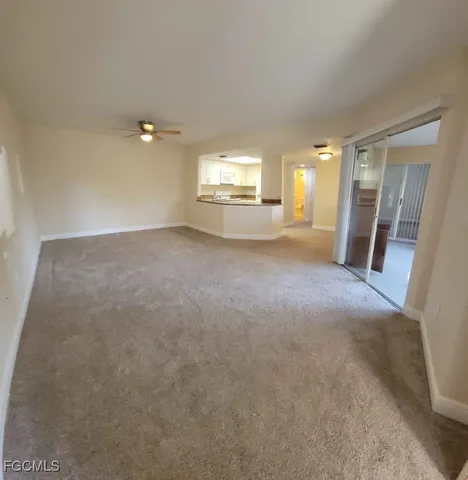 a view of a room with furniture and a window