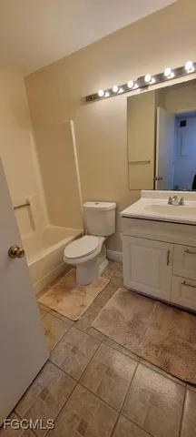 a bathroom with a toilet a sink and shower