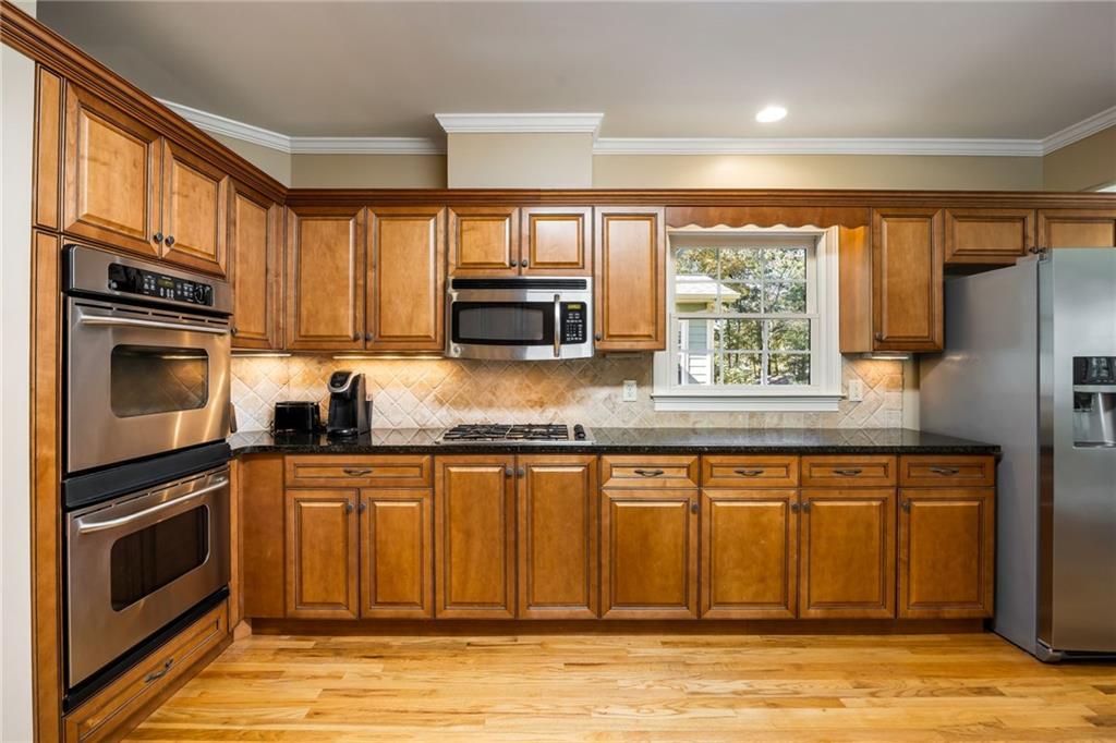 1505 Old John Ward Road Marietta, GA 30064 - Photo 14 of 46 a kitchen with granite countertop a refrigerator stove top oven and sink