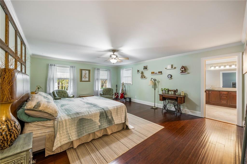 1505 Old John Ward Road Marietta, GA 30064 - Photo 18 of 46 a spacious bedroom with a bed and wooden floor