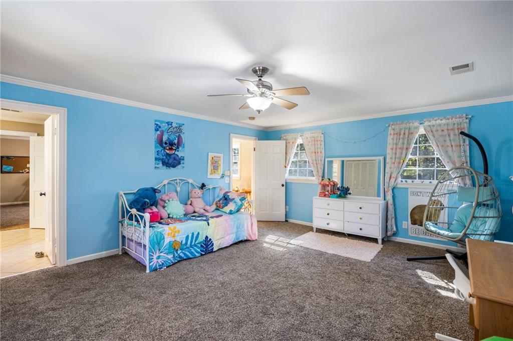1505 Old John Ward Road Marietta, GA 30064 - Photo 23 of 46 a view of a bedroom with baby crib cabinet and a chandelier