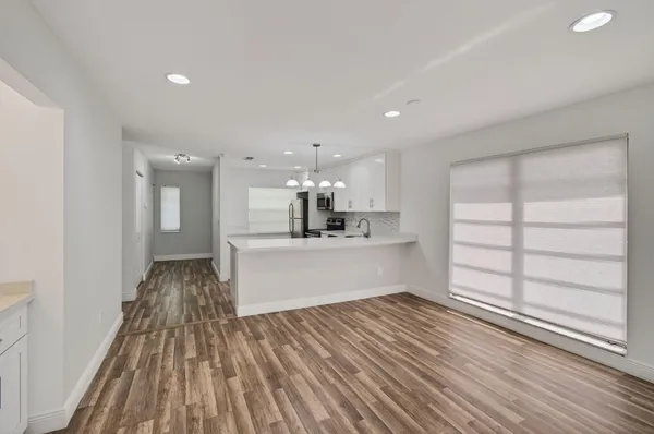 a kitchen with stainless steel appliances granite countertop a stove a refrigerator and a microwave