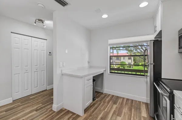 a view of hallway with wooden floor