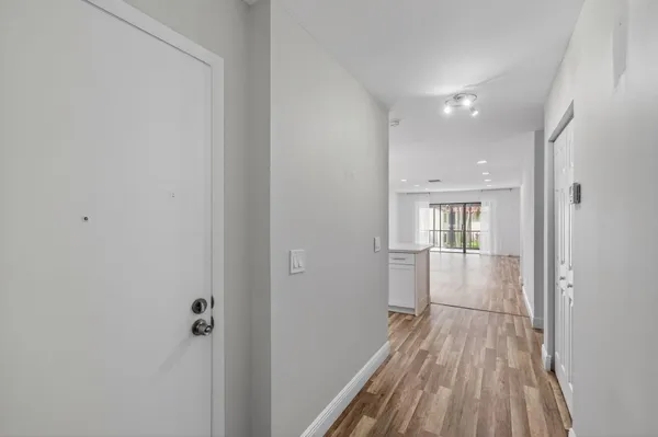 a kitchen with stainless steel appliances granite countertop a sink cabinets and wooden floor