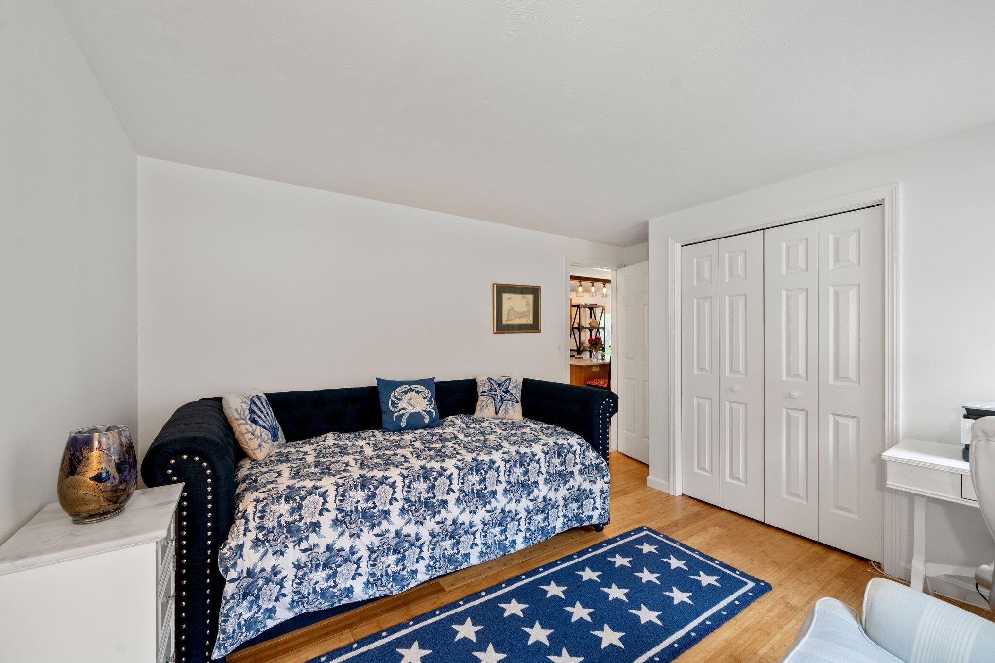 40 Sam Ryder Road Chatham, MA 02633 - Photo 16 of 42 a bedroom with a bed and wooden floor
