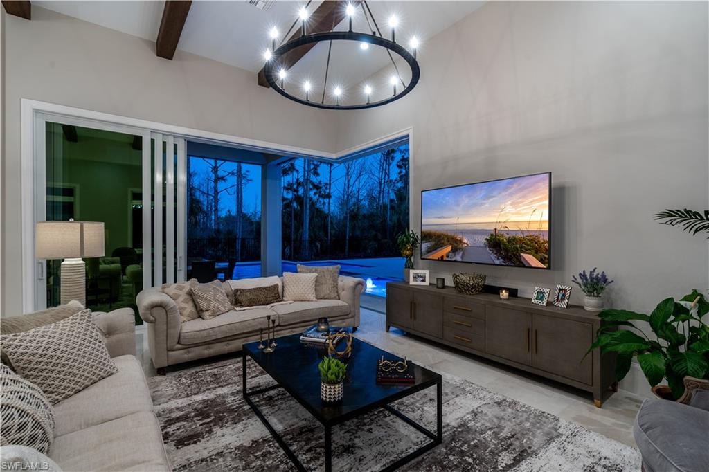 4478 Wayside Drive Naples, FL 34119 - Photo 12 of 31 a living room with furniture and a flat screen tv